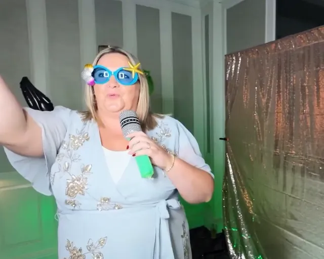 Guest singing into a microphone in blue party glasses