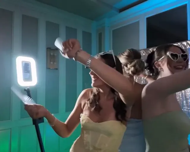 Friends dancing under blue lights as the ring light passes